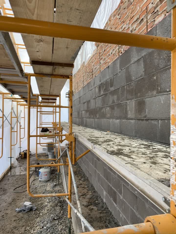 Scaffolding along the new block wall