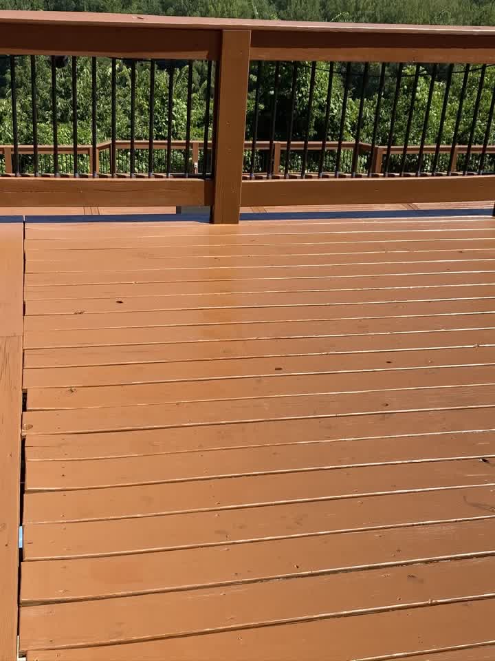Close-up of stained deck railing and balusters