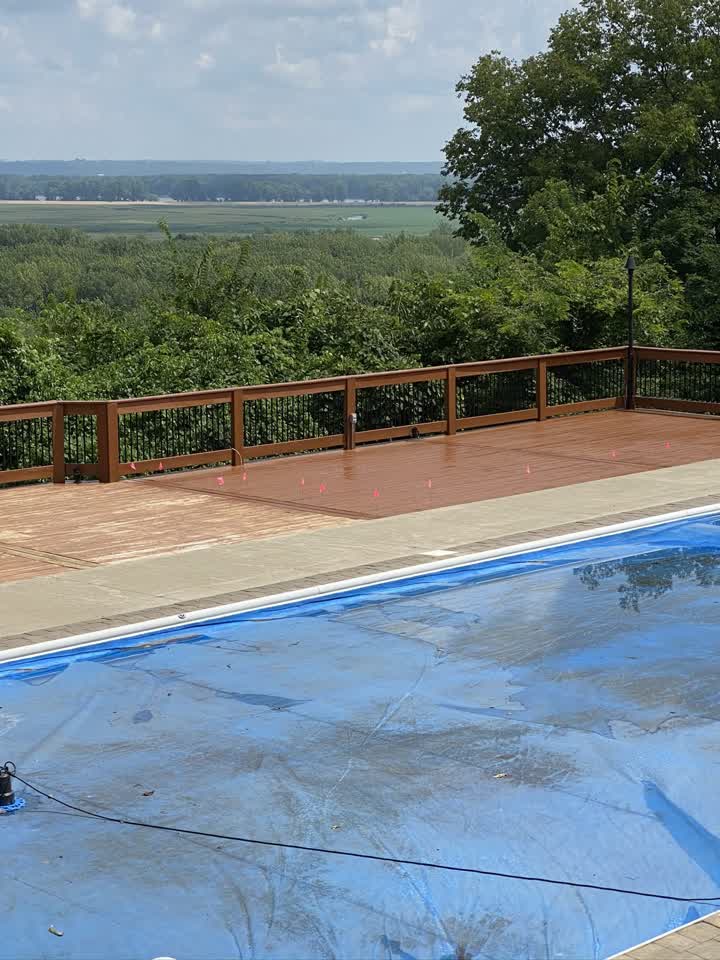 Stained deck beside the pool with a valley view