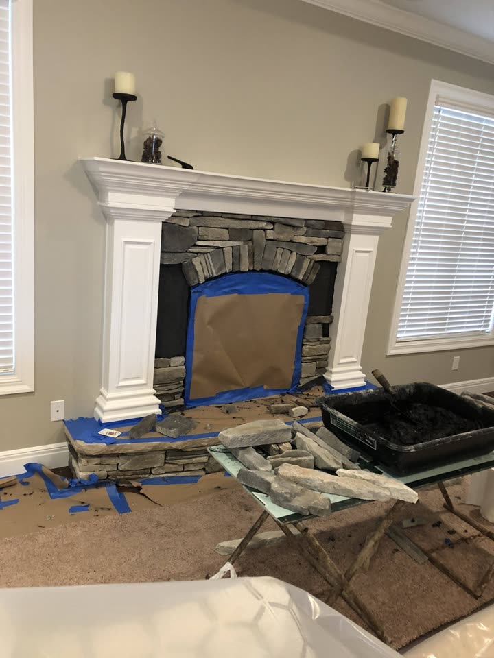 Stone veneer being applied to the fireplace