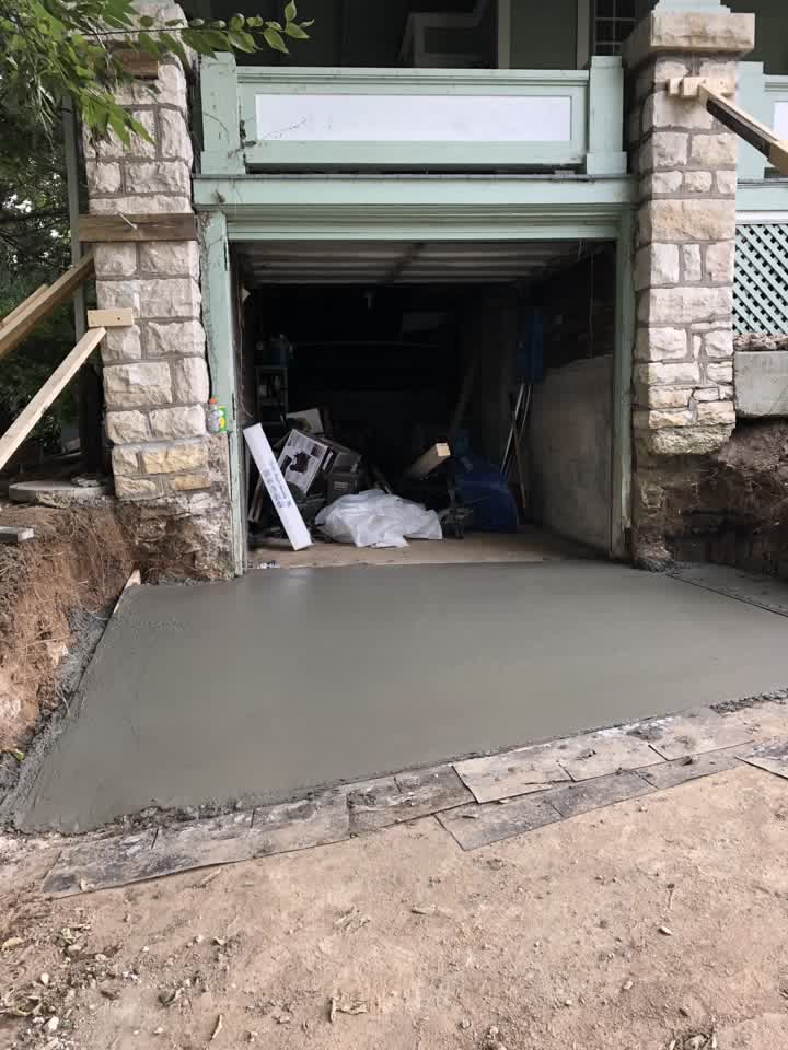 Fresh concrete driveway poured in front of the garage