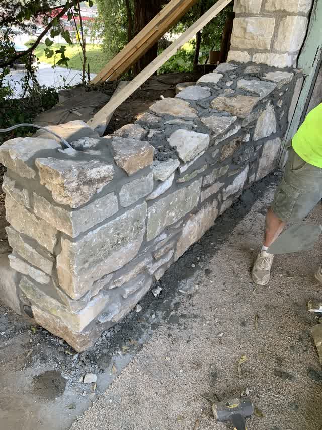 Stone wall being laid by hand