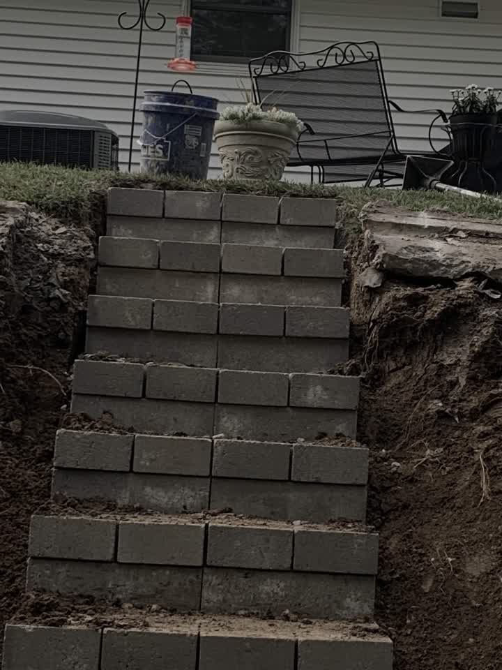 Block steps under construction beside the house