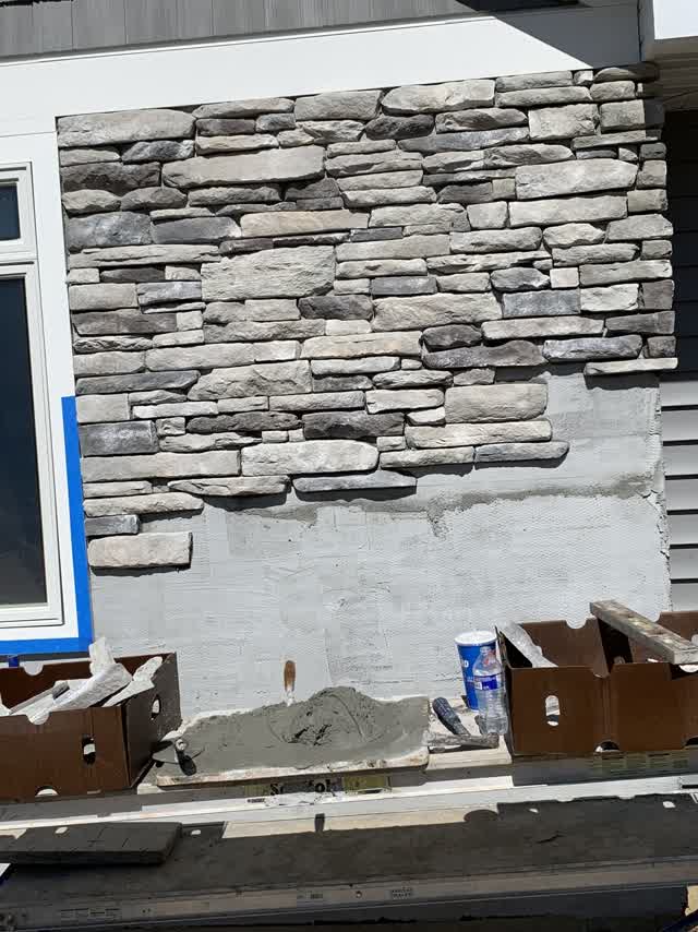 Stacked stone veneer going up on the wall