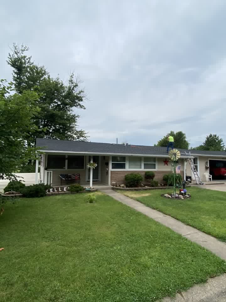 Ranch house with new dark shingle roof