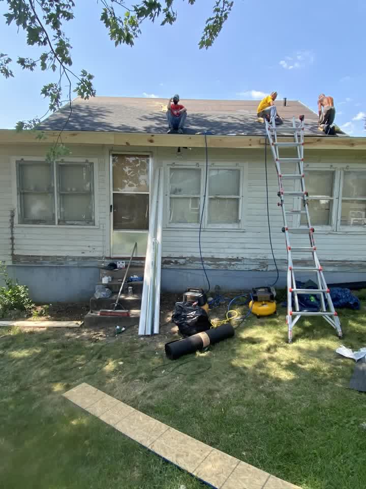 Roofing crew installing new shingles