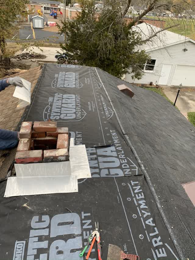 Synthetic underlayment and chimney flashing in progress
