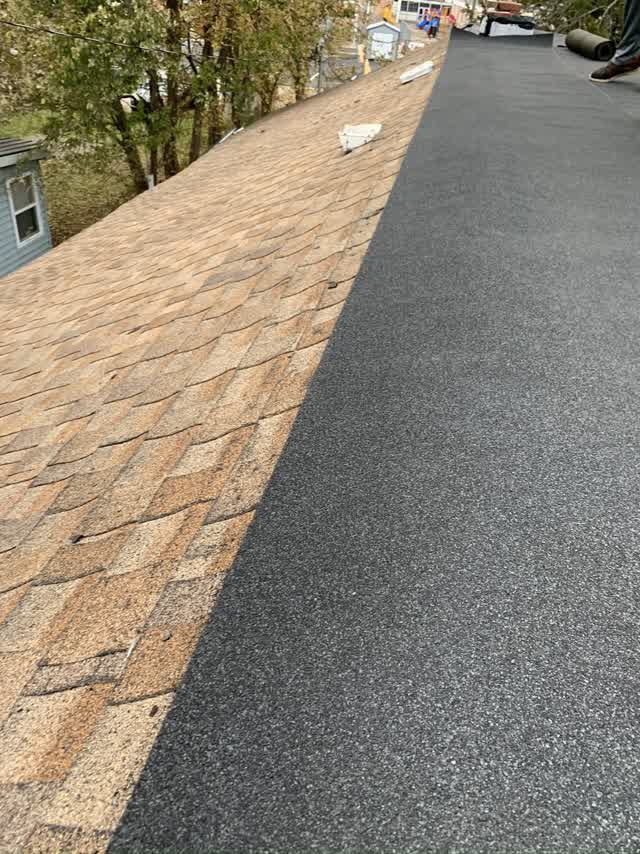 Old shakes stripped with new membrane going on