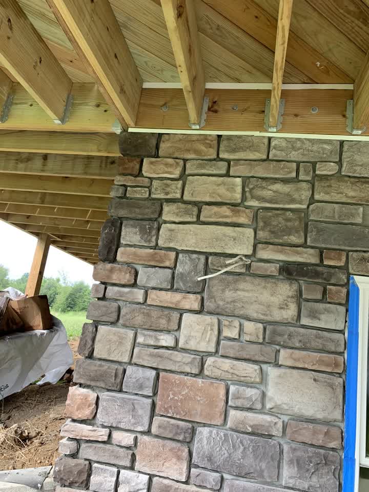Stone veneer pillar under the deck