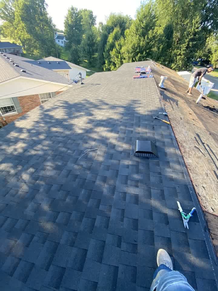 Tarped roof section with tear-off in progress