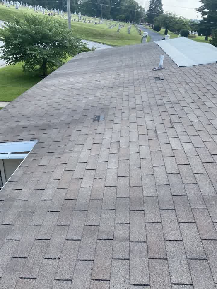 White tarp covering a damaged roof slope